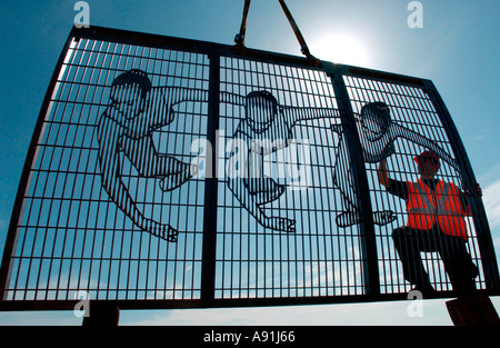 The art of car parking. Artist "Bruce Williams" makes graceful screens of dancers to hide an ugly carpark. Stock Photo