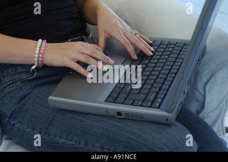 Womans hands typing on a laptop keyboard Stock Photo