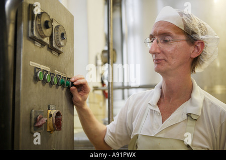 The cheese dairy Dairy expert in the operating room in which the milk is centrifuged Stock Photo