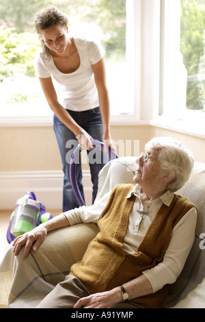 teenager helping an old lady Stock Photo