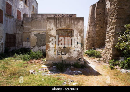 derelict building or hotel in Tarifa, Andalucia, Spain with rusty barred windows Stock Photo