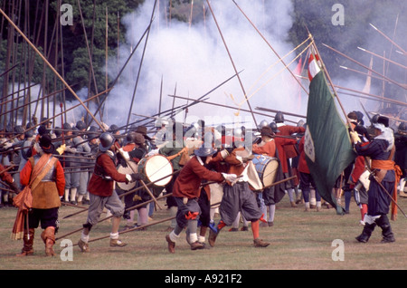 English Civil War preparing for reenactment battle by groups like English Civil War Society & Sealed Knot members as pikemen smoke from muskets firing Stock Photo