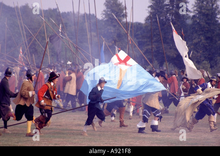 English Civil War preparing for reenactment battle by groups like English Civil War Society & Sealed Knot members as pikemen & flag bearers Stock Photo