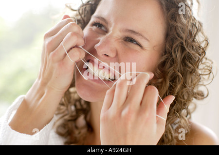 Girl flossing teeth Stock Photo