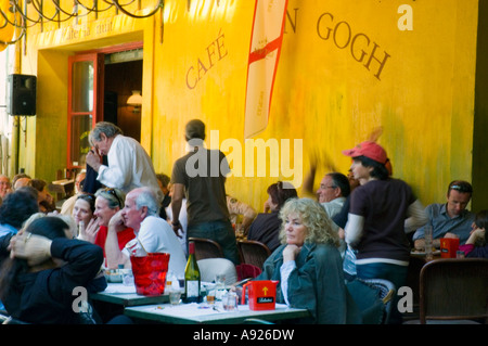 Arles France, Crowd in Van Gogh, Traditional French Cafe Bistro Restaurant Terrace 'Cafe la Nuit' WOMAN DRINKING OUTSIDE AT PUB Stock Photo
