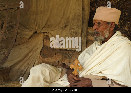 Ethiopian Orthodox Priest at monastery on Zege peninsula on shores of Lake Tana, Ethiopia.  He holds a traditional cross. Stock Photo