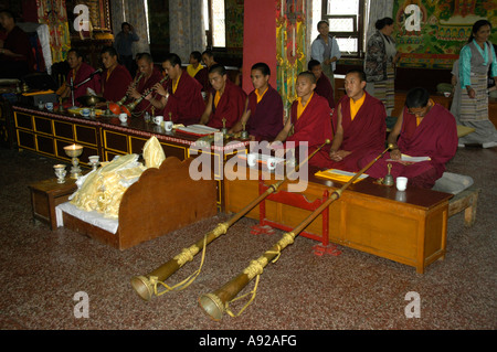 Buddhist monks at meditation and playing trompets Bodhnath Stupa Kathmandu Nepal Stock Photo