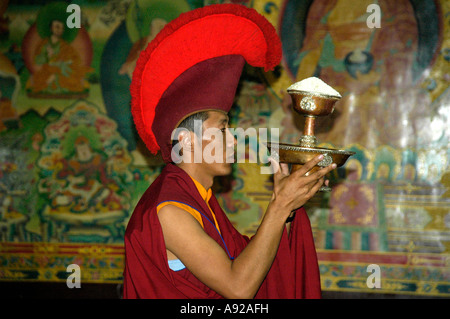 Portrait Buddhist monk of the red cap sect is wearing a specific red cap Bodhnath Stupa Kathmandu Nepal Stock Photo