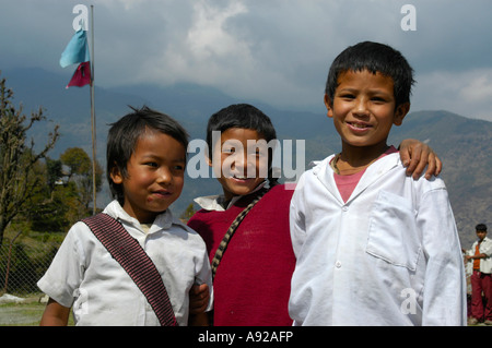 Three school boys Landruk near Pokhara Nepal Stock Photo