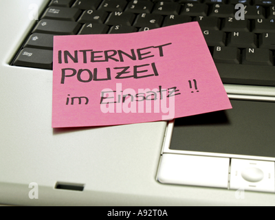 memo note on notebook internet police in service Stock Photo