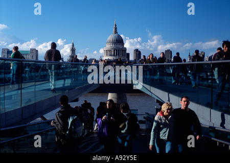 Tourists cross the Millenium Bridge over the River Thames Central London England UK Britain Europe Stock Photo