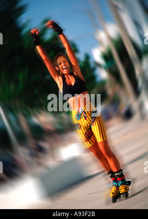 Attractive young woman rollerblading outdoors Stock Photo