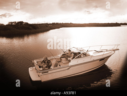 Father and sons fishing together with the family dog Stock Photo