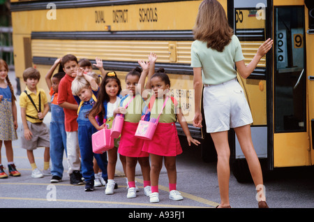 Students Standing At The Door Of A School Bus Stock Photo - Alamy