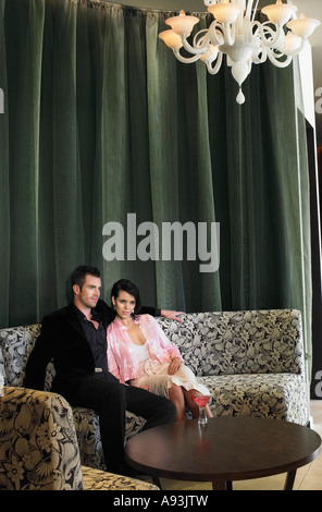 Couple sitting in hotel lobby Stock Photo