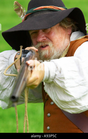 17th century Civil War Musketeer aiming his matchlock musket. Played by ...