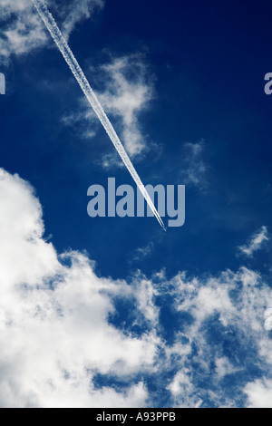 Transatlantic aircraft with contrails flying over Wales UK Stock Photo