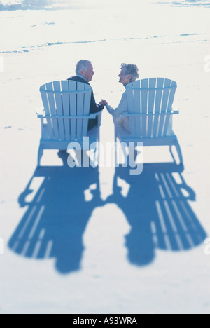 Rear view of a senior couple sitting on the beach Stock Photo - Alamy