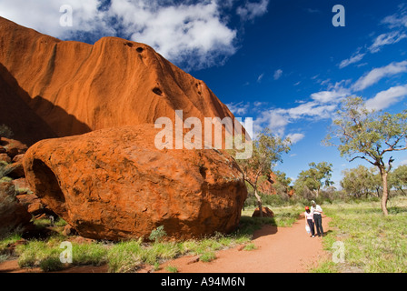 Walkers on the  base walk around perimeter of Ayers Rock in Northern Territories Australia Stock Photo