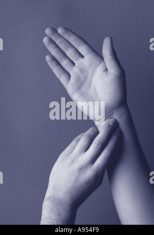 Hand taking pulse Stock Photo