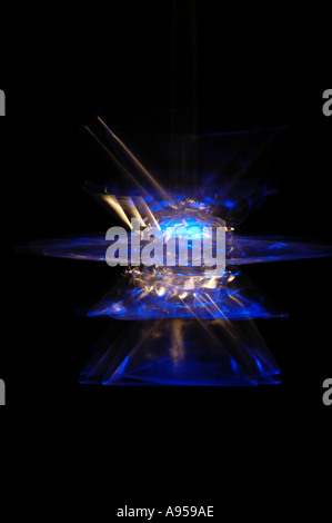 Illuminated blue star light swinging and blurred with movement. On black background. Stock Photo