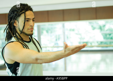 Man reaching out arm, waist up Stock Photo