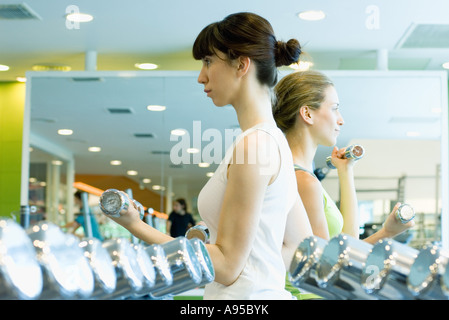 Two women working out with dumbbells Stock Photo