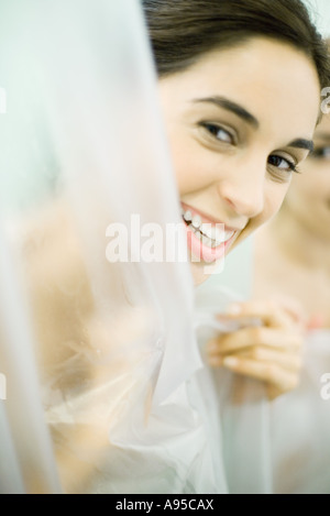 Woman looking at camera from behind shower Stock Photo