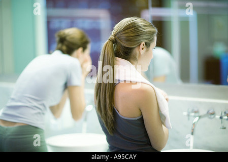Women in public restroom, facing mirror Stock Photo
