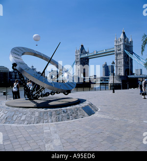 Modern sundial with Tower Bridge over River Thames beyond, from St. Katherine's Dock, London, England, UK.  Photograph taken 17 July 1999. Stock Photo