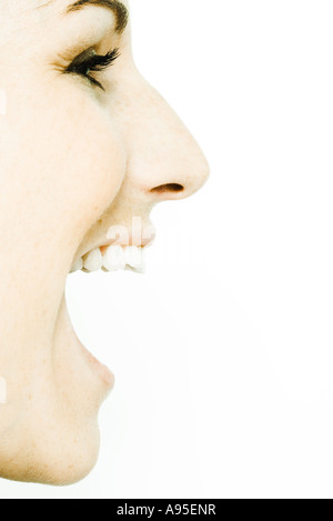 Young woman's face with mouth wide open, profile Stock Photo