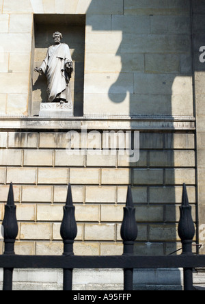 Statue of St. Peter in wall alcove, iron gate in foreground Stock Photo