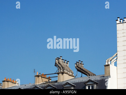 Smoke stacks on top of apartment building Stock Photo