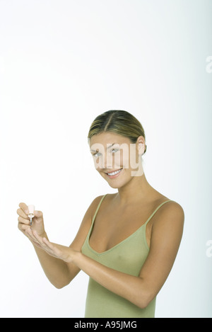 Young woman polishing nails Stock Photo