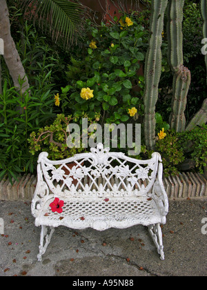 A White Victorian Style Bench with Flores Stock Photo