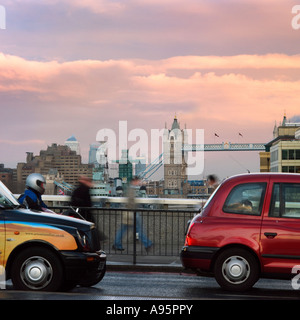 taxis crossing london bridge at daylight with tower bridge Stock Photo