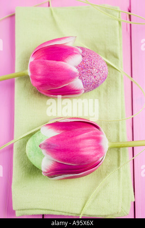 Two tulips with hand painted Easter eggs within their blossoms Stock Photo