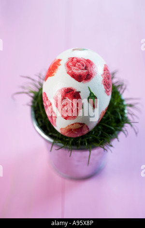 Easter egg in flowerpot with Easter grass Stock Photo