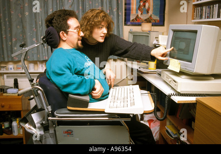 Disabled man working on his computer in residential home. Stock Photo