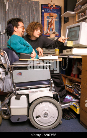 Disabled man working on his computer in residential home. Stock Photo