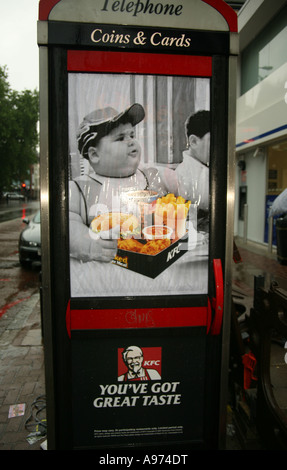 Protest poster against fatty food on the side of a phone box Brick Lane London Stock Photo