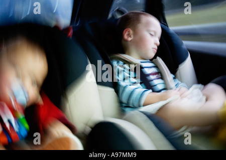 CHILDREN SLEEPING IN THE CAR Stock Photo
