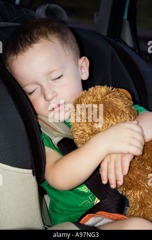 BOY SLEEPING IN CAR SEAT Stock Photo