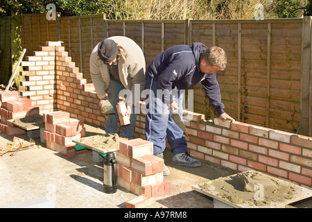 A bricklayer constructing a wall for a garage Stock Photo