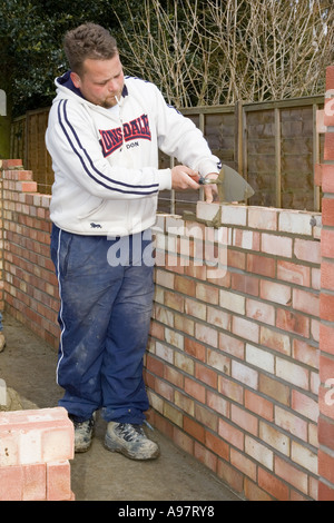 A bricklayer constructing a wall for a garage Stock Photo