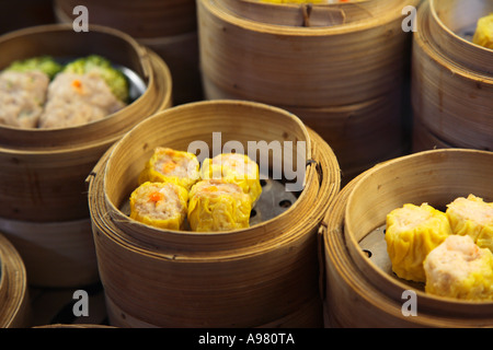 Dim Sum or Chinese dumpling in a stream hot pot of food wheelbarrow on  street food of Bangkok. Many dumpling in a wooden basket is streaming in  old As Stock Photo 