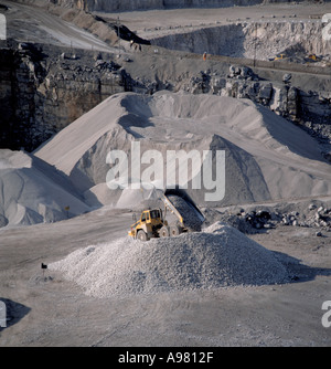 Dump truck tipping crushed limestone at Dene Quarry, Cromford, Peak District National Park, Derbyshire, England, UK. Stock Photo