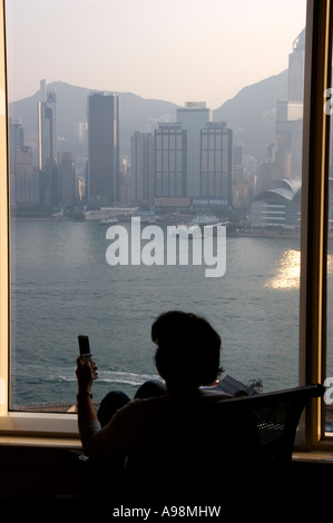 Woman using cellphone in Hong Kong city Stock Photo - Alamy