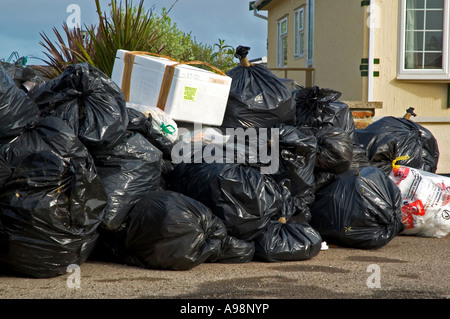 a large pile of black bin bags waiting to be collected,in cornwall,england Stock Photo