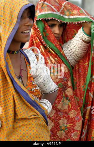 Banni Tribal girls  wear massed traditional bangles and brilliant coloured clothes in Gujarat,India Stock Photo